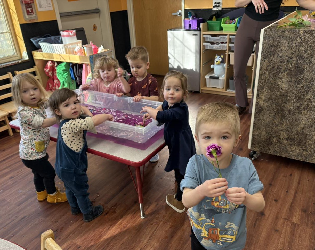 Kids holding flower leaves