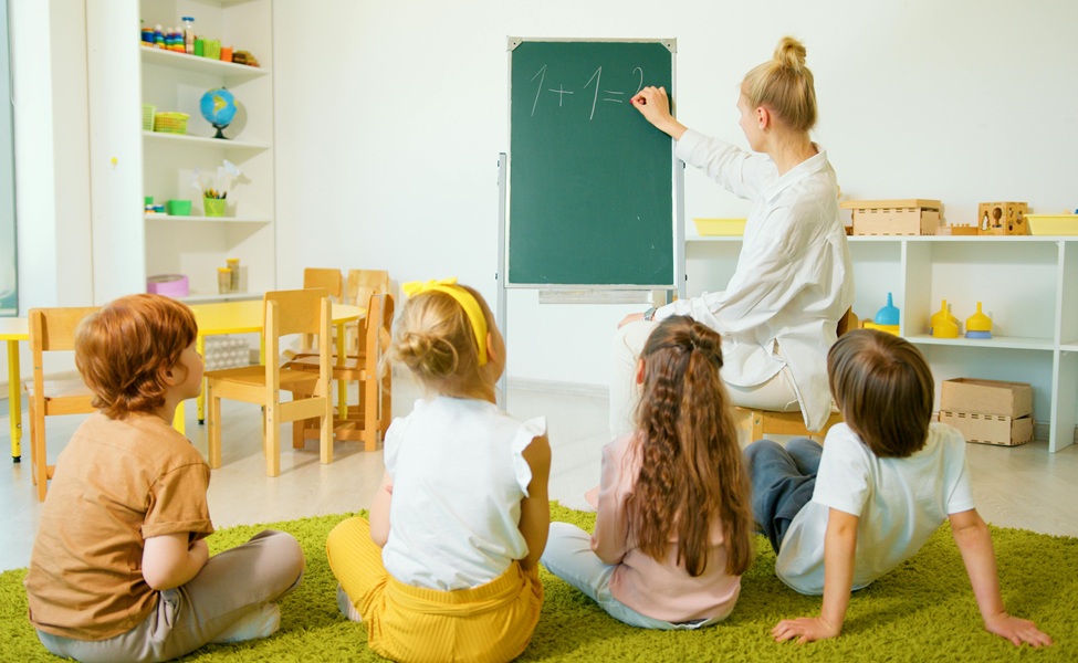 Kids watching teacher writing on board