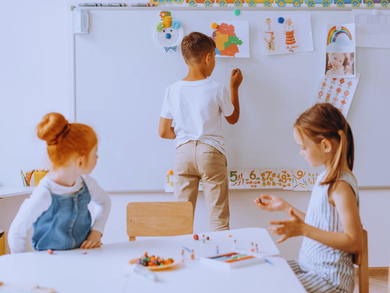 Kid writing on whiteboard