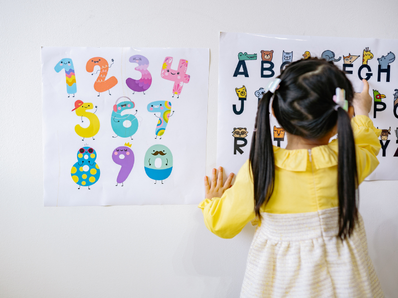 Child on the numbers and letter board